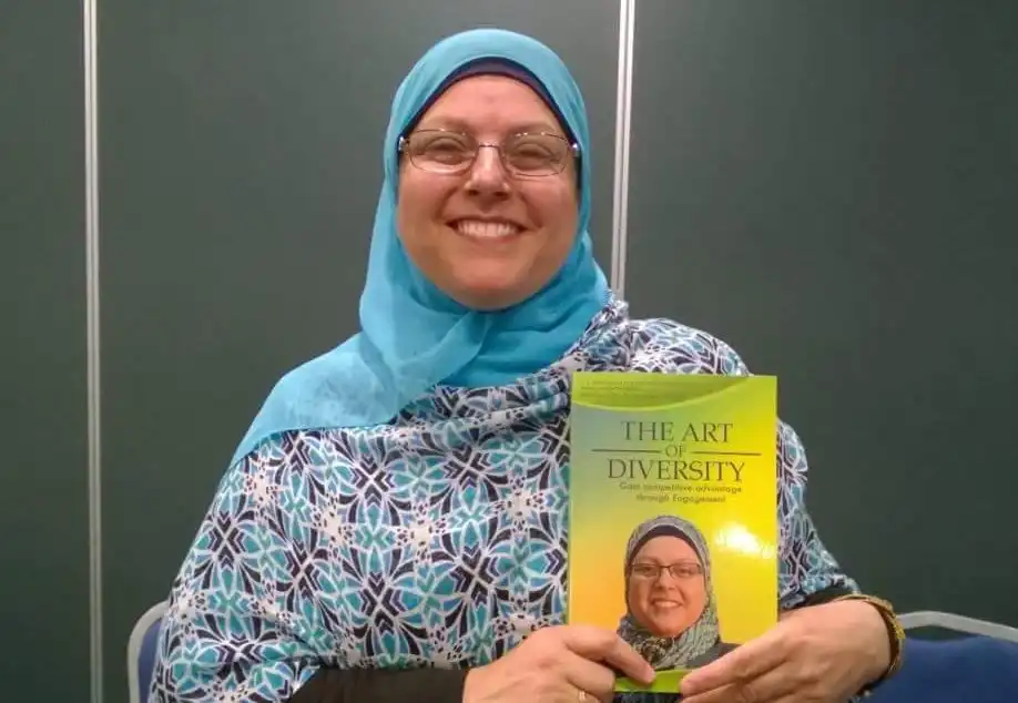 Najla Turk holding her book The Art of Diversity